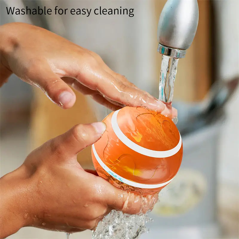 Orange ball with white stripe being washed for the Intelligent USB Cat Wicked Ball Toy.