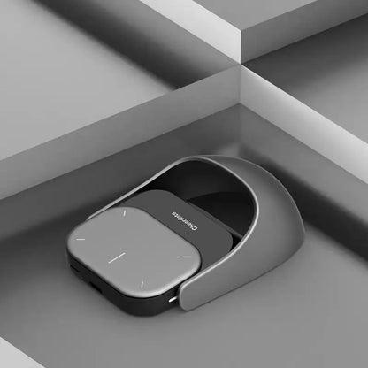 Gray and black Smart Split Air Mouse in a cradle with wireless charging functionality